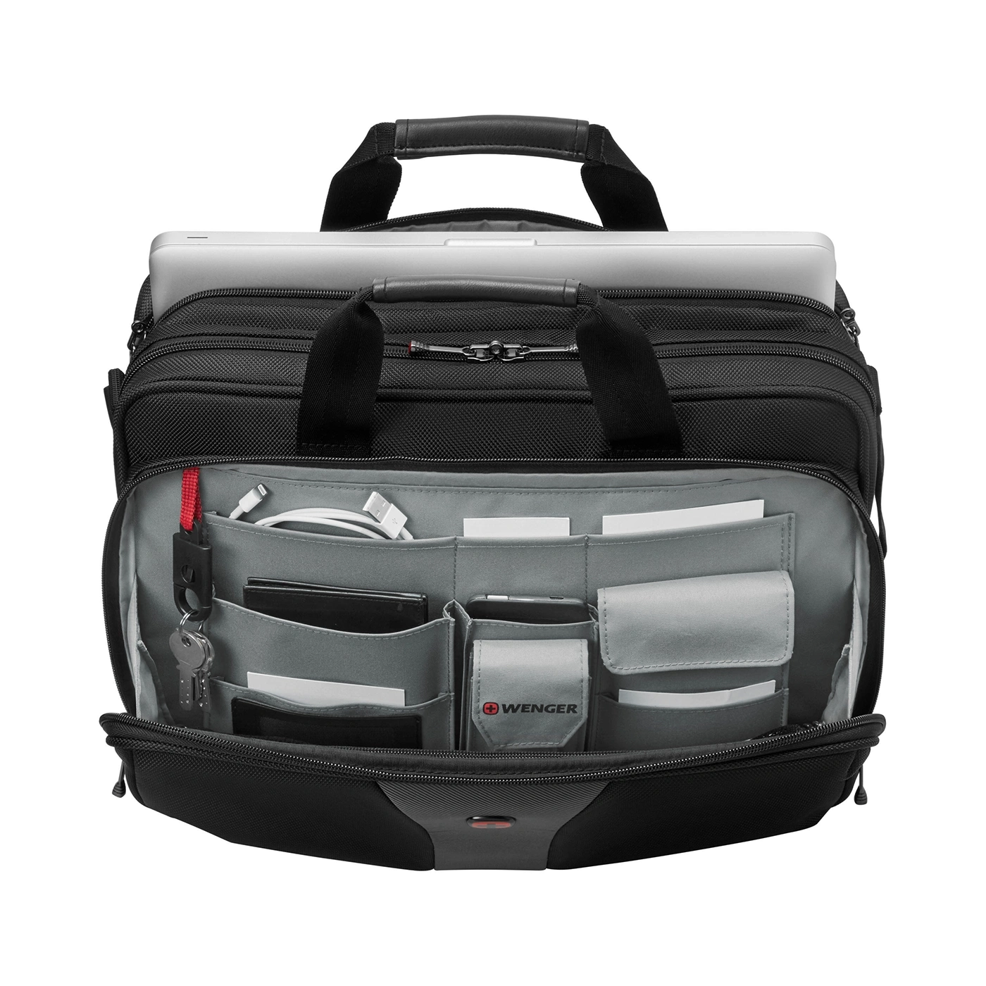 Black briefcase with laptop and accessories, open, on a black background.