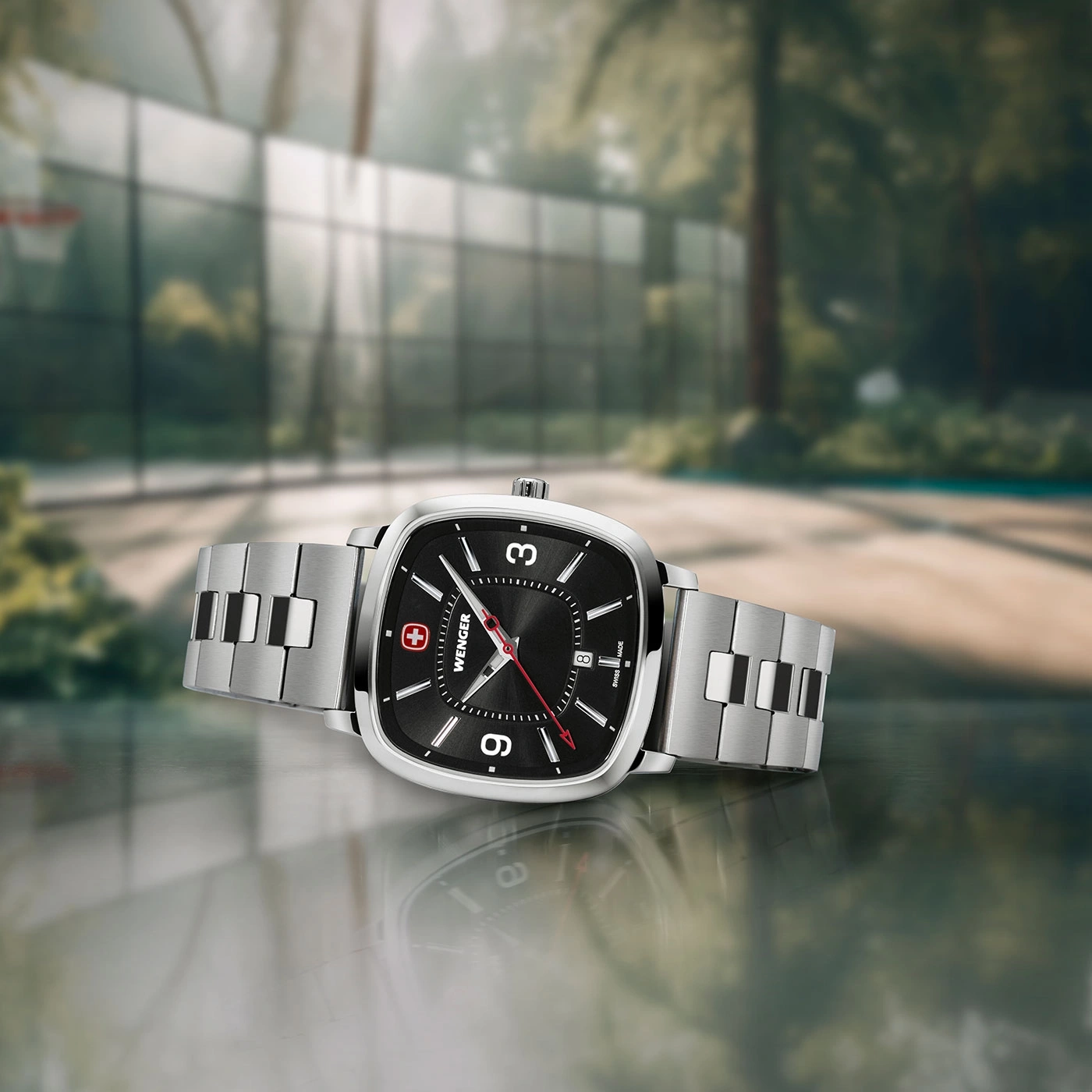Wenger watch on a smooth surface with a basketball court in the background