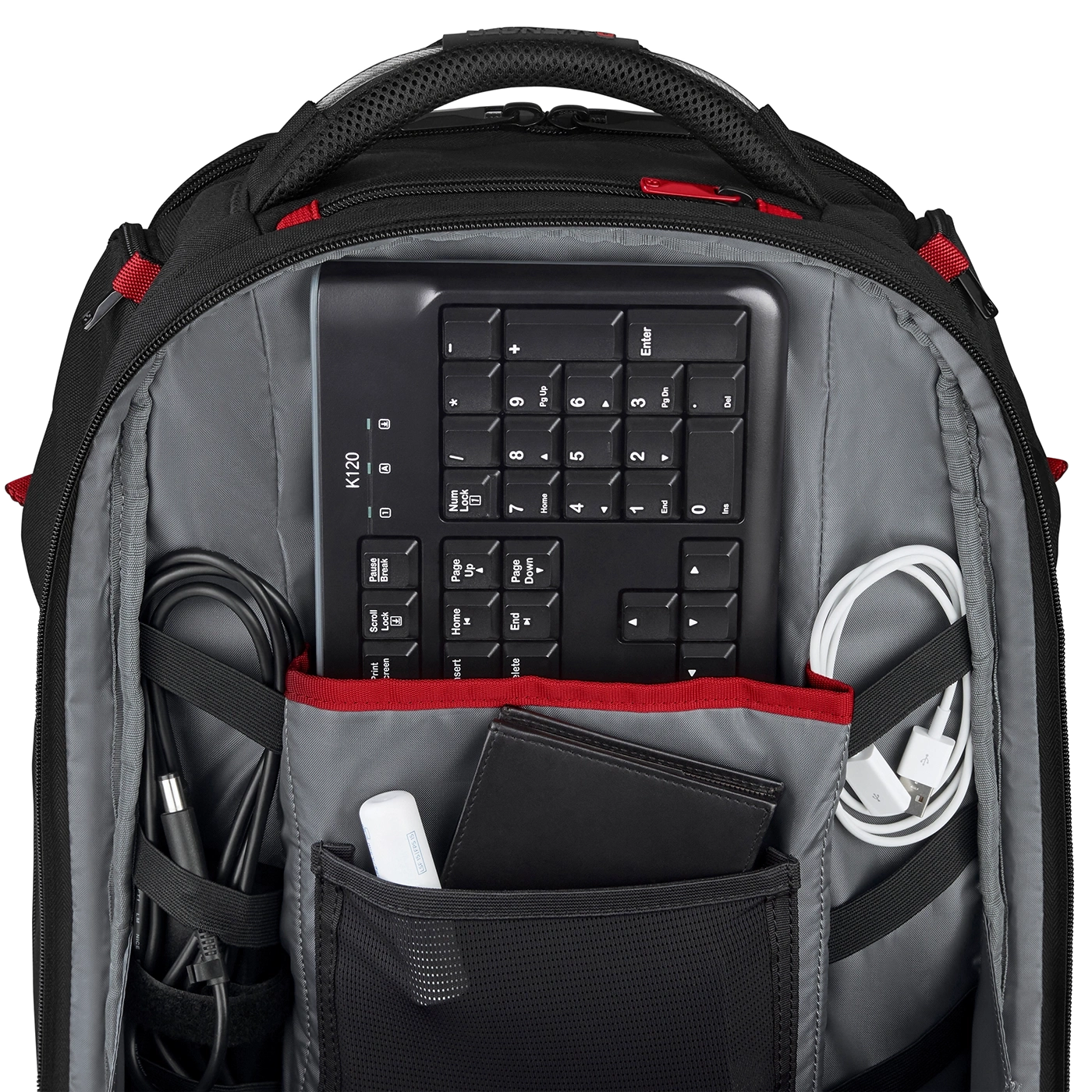 Schwarzer Rucksack mit Tastatur, Kabeln und Zubehör. Gut organisiert und gepackt.