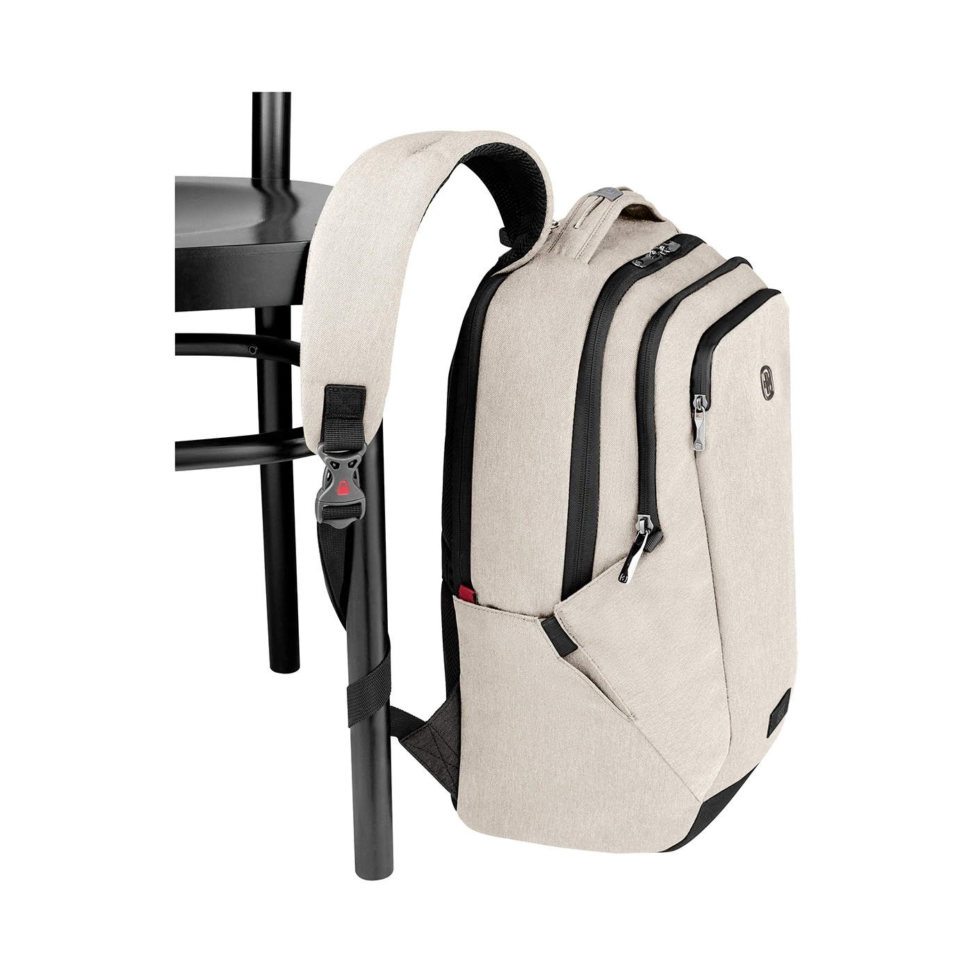 Beige backpack leaning against black chair, isolated on white background