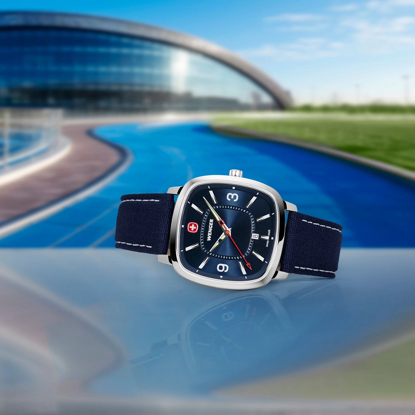 Wenger Uhr mit blauem Zifferblatt und Armband vor blauem Hintergrund