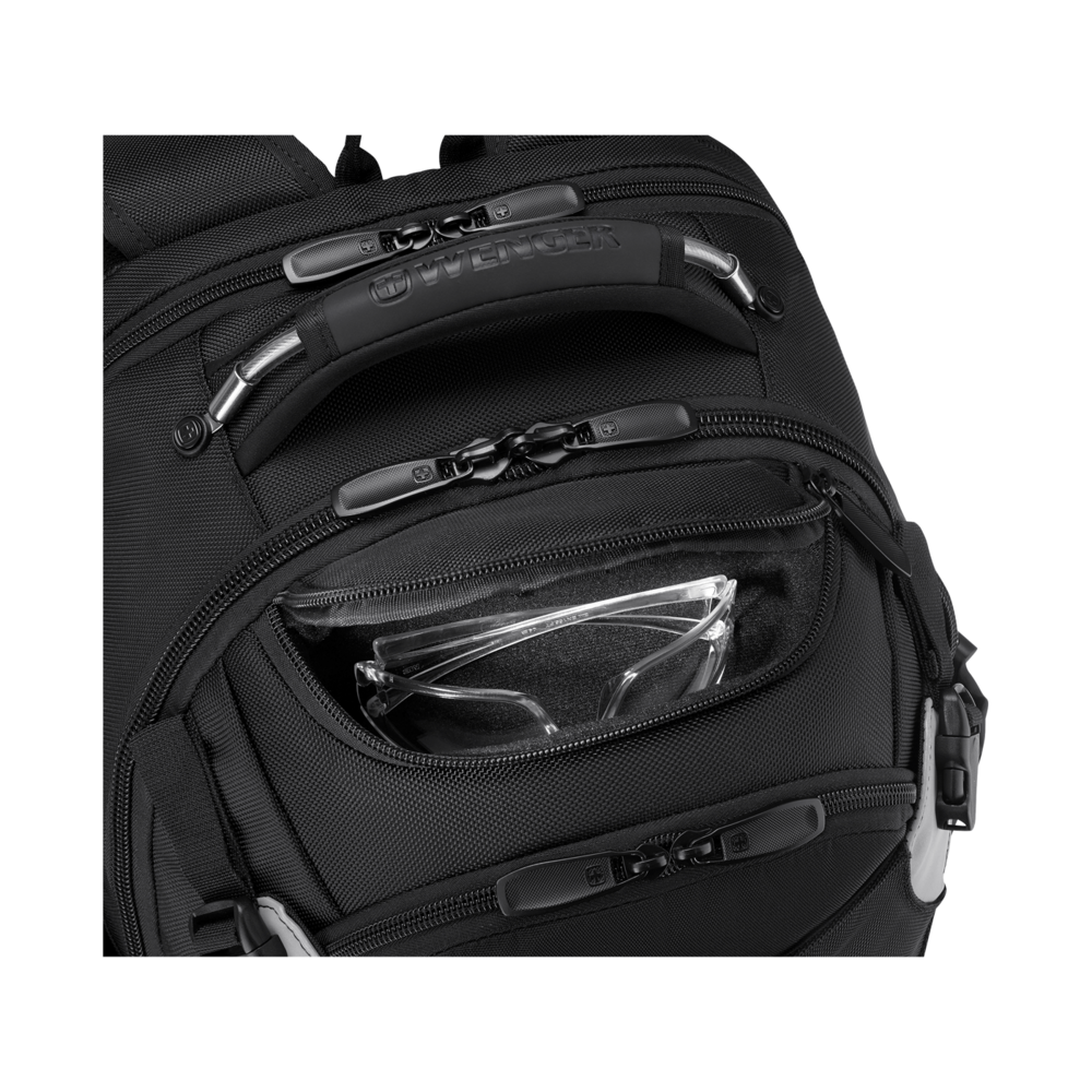 Close-up of a black backpack with zippers and a pocket holding eyeglasses.