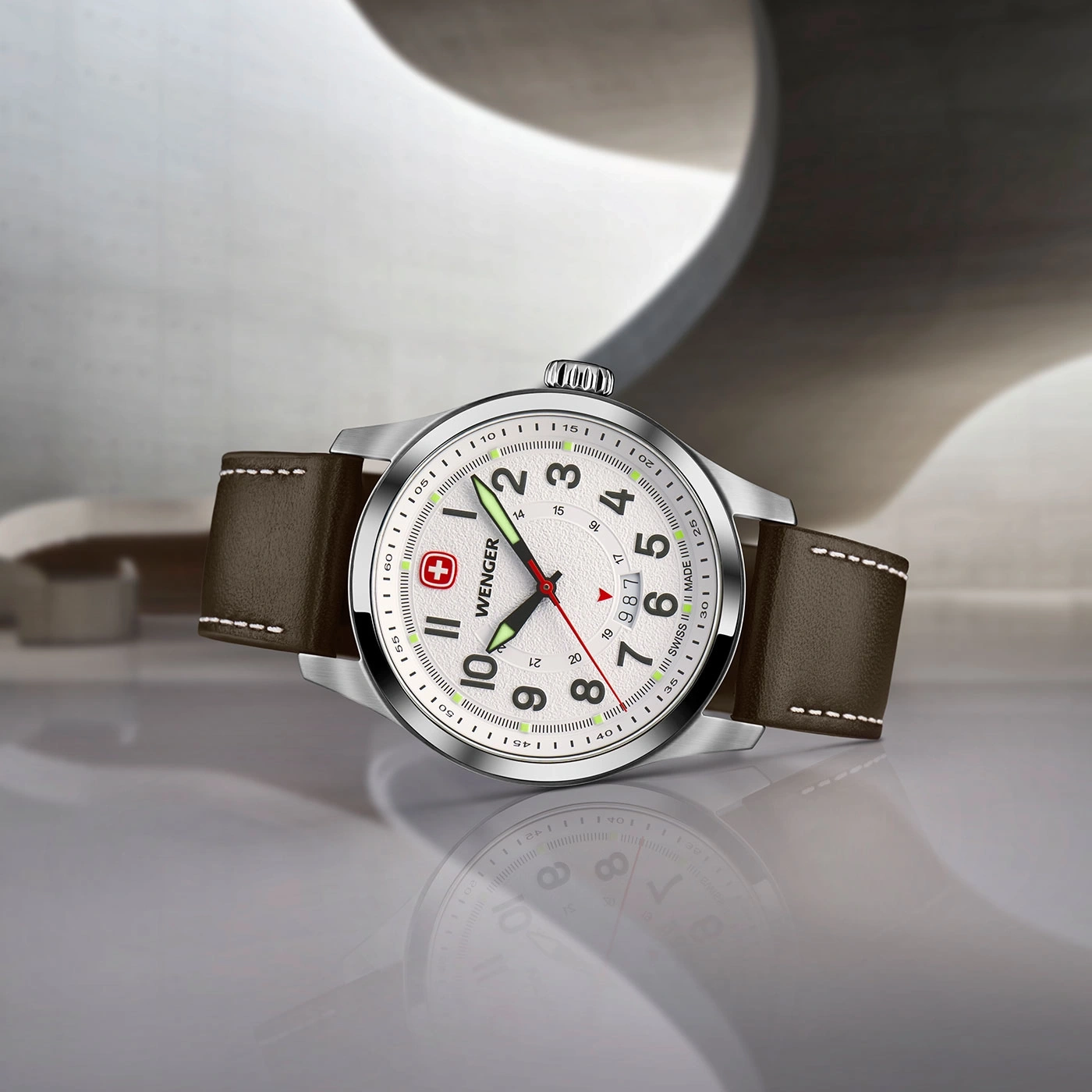 Wenger watch with brown leather strap, white face, and a reflection on the surface.