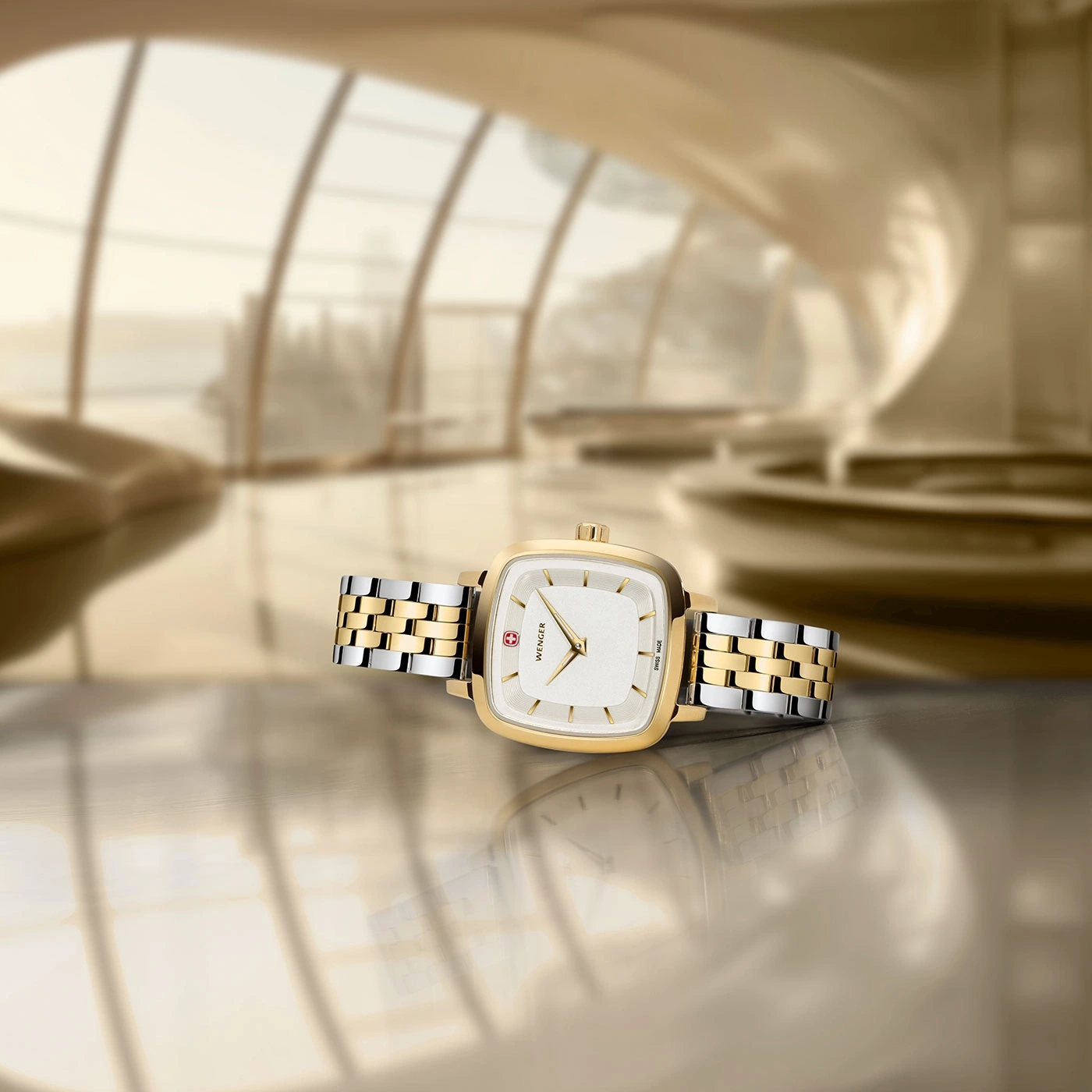 Wenger watch, gold face, two-tone band, luxurious setting, reflection on surface