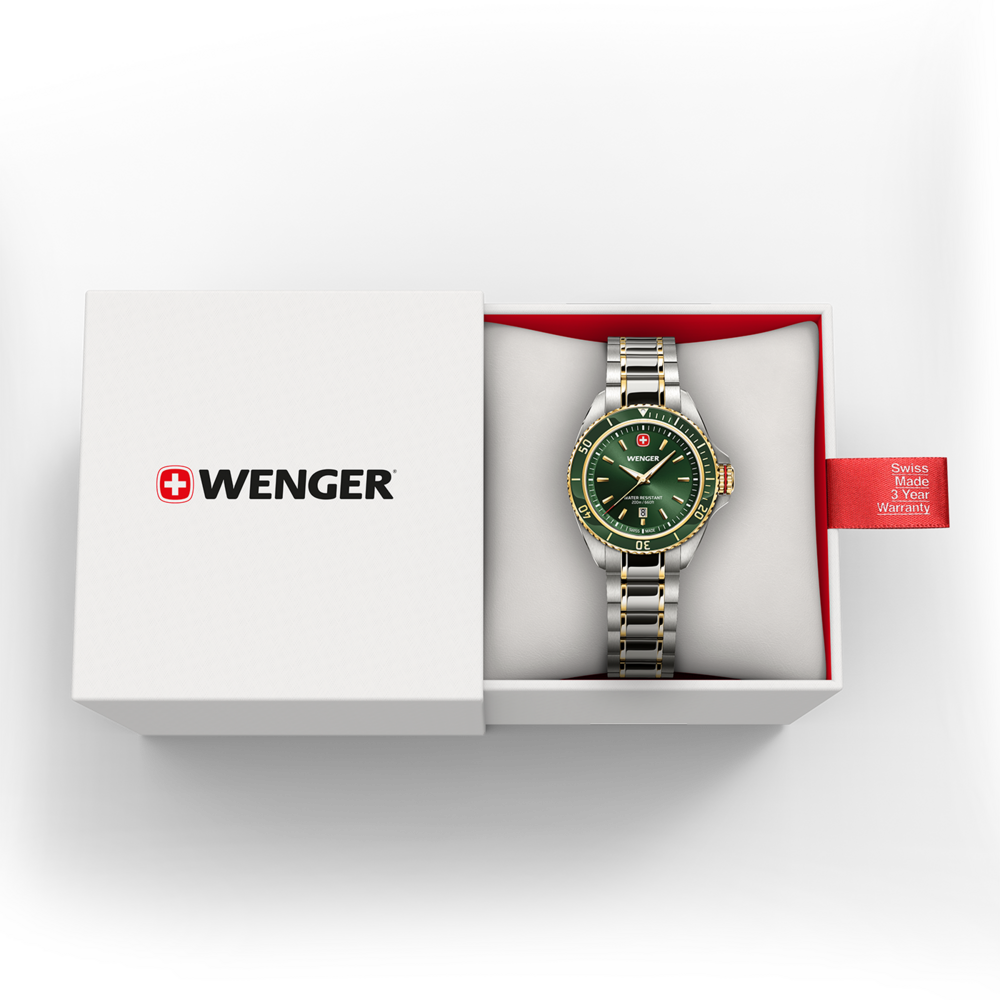 Une montre verte Wenger avec bracelet argent et or dans une boîte blanche avec étiquette de garantie rouge.