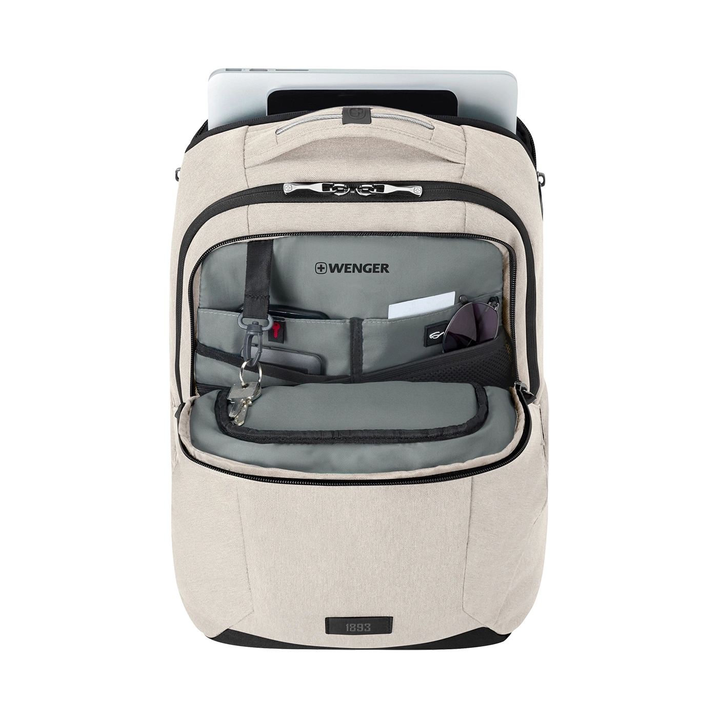 Beige backpack with open compartment, laptop, and accessories visible.
