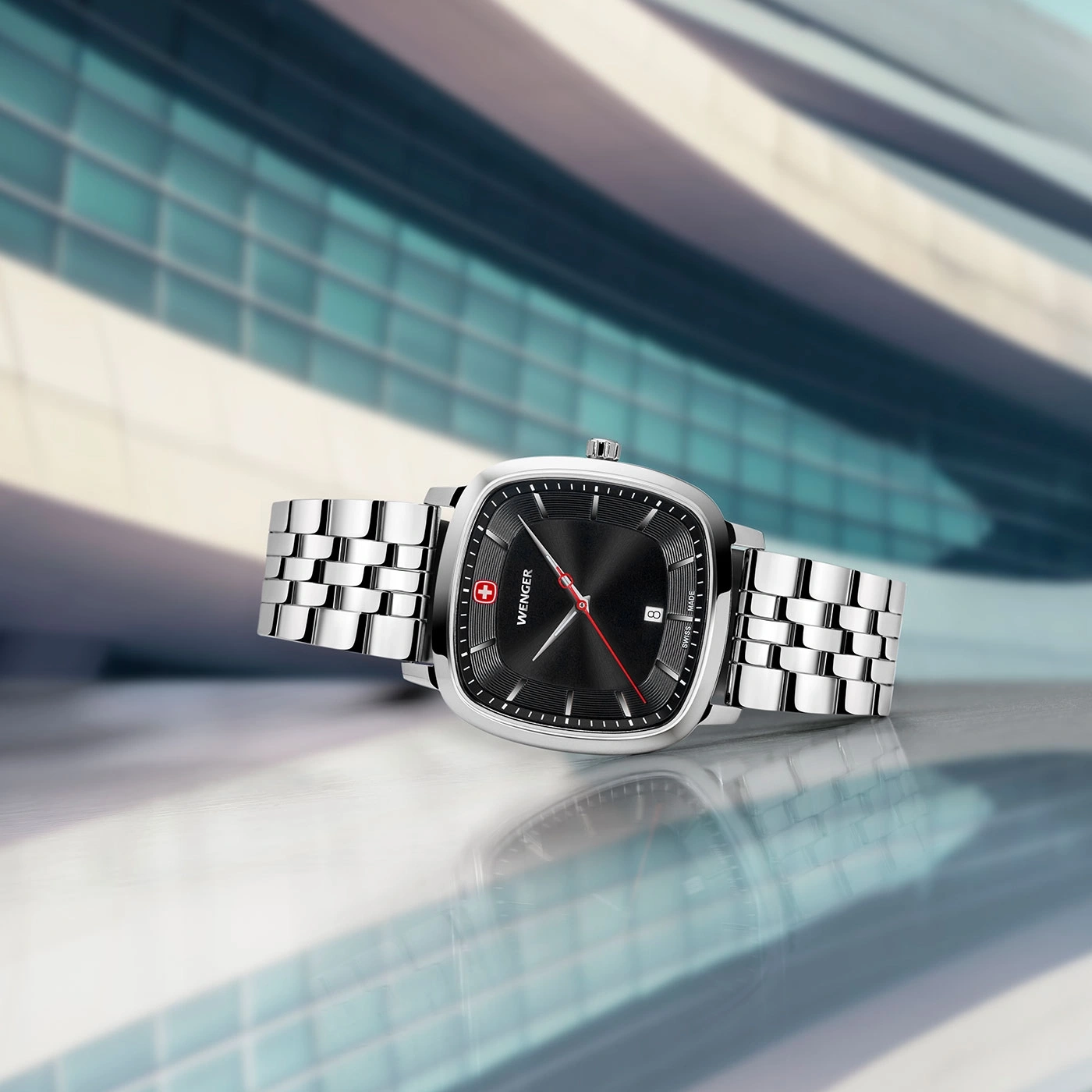 Close-up of a Wenger watch with a black face and silver band, modern design.
