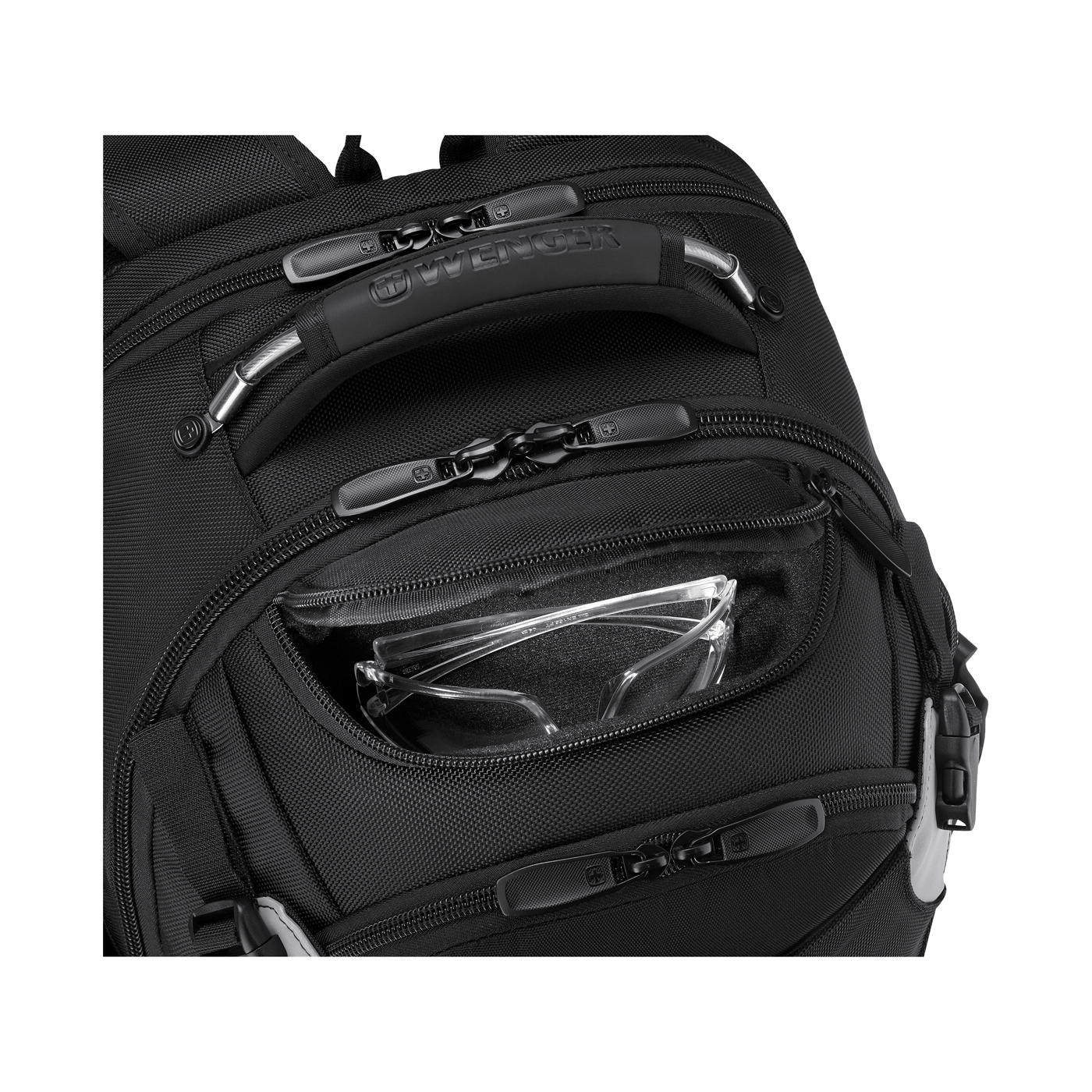 Close-up of a black backpack with zippers and a pocket holding eyeglasses.