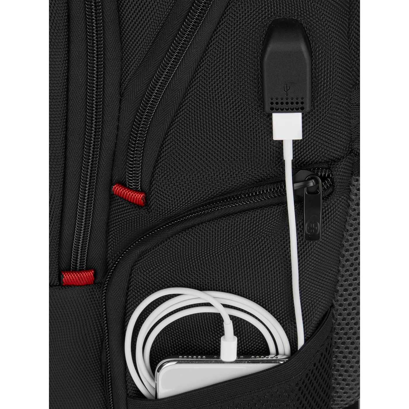 Black backpack with USB port and white cable charging a phone in the pocket.
